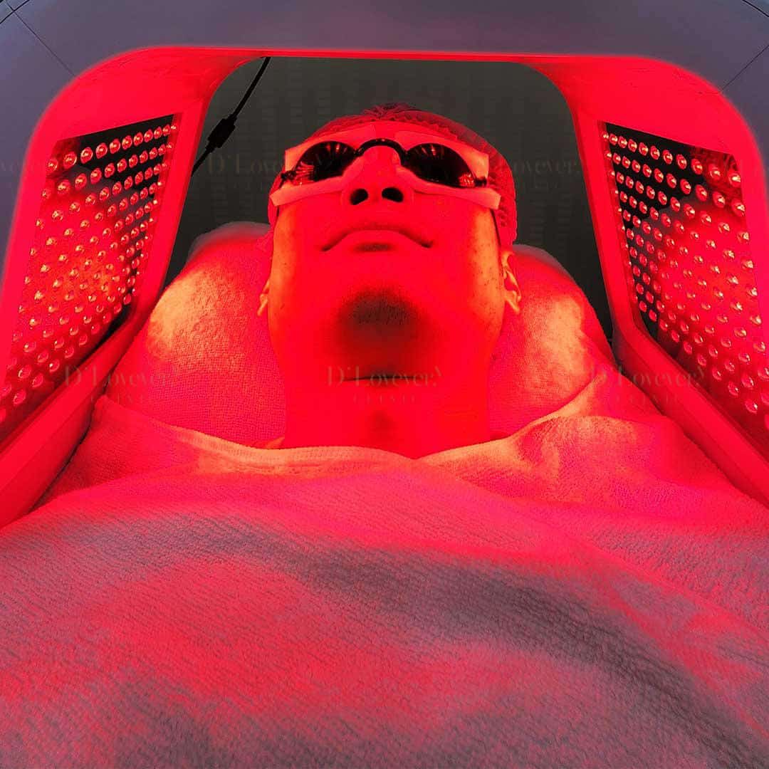 Red LED light therapy facial with protective goggles for skin rejuvenation