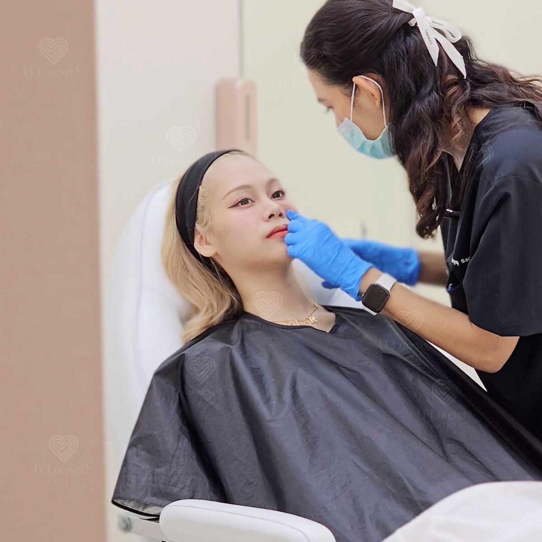 Under-eye thread lift treatment in clinic with masked practitioner and reclined patient