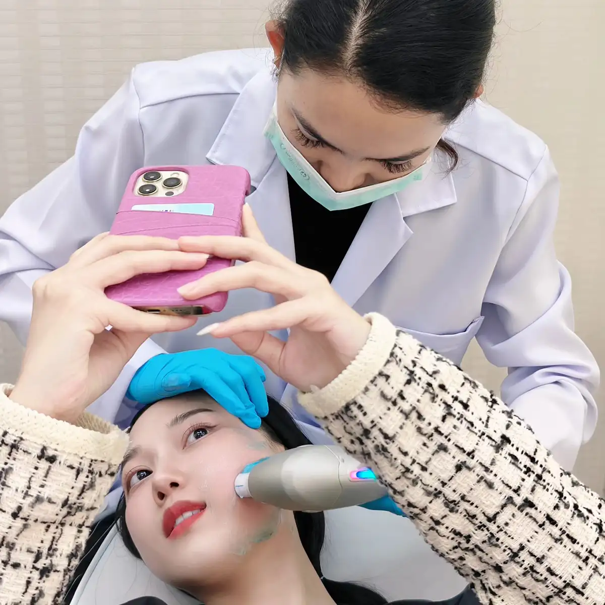 HIFU facial treatment: patient selfie while clinician applies handheld device in clinic