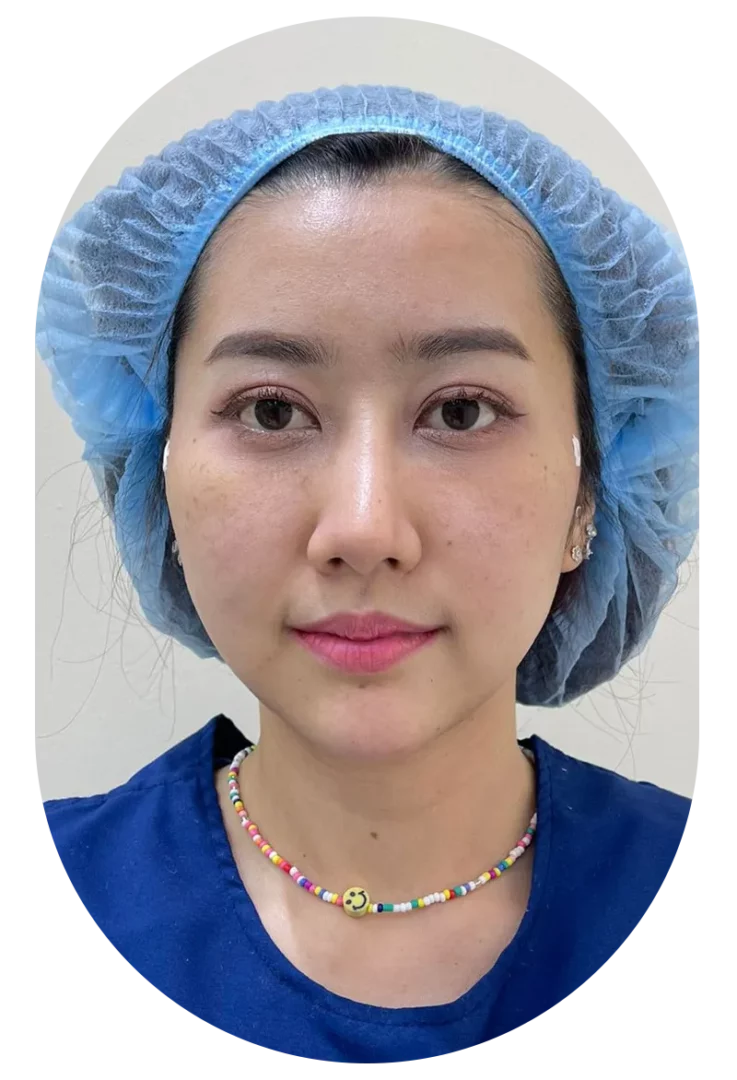 Pre-treatment clinical portrait of patient wearing blue surgical cap and navy top