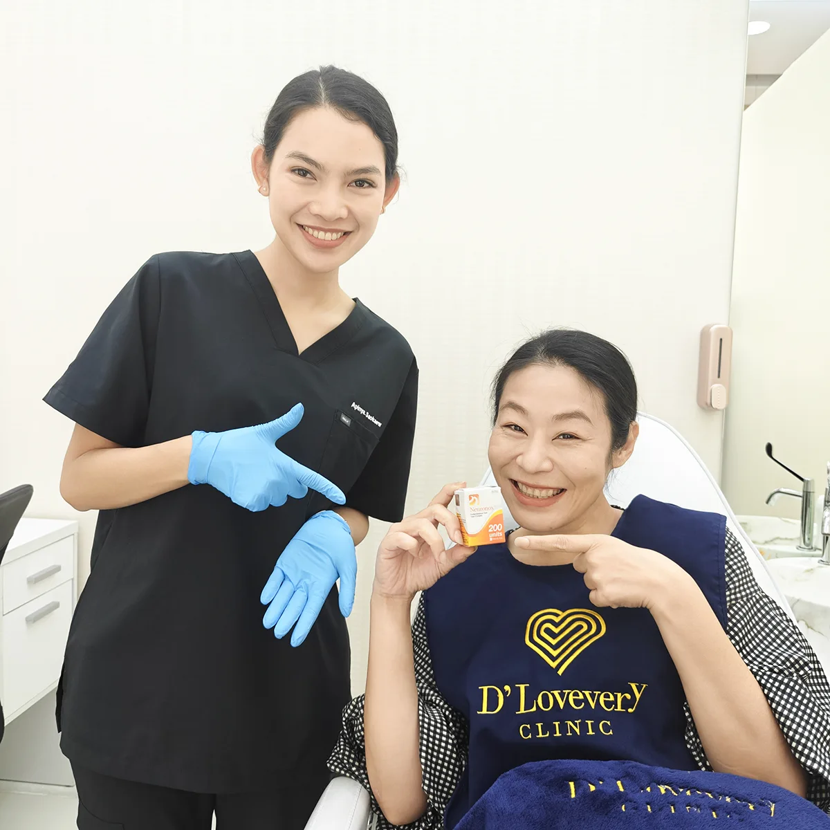 Smiling patient and gloved staff in Botox clinic display small product box.