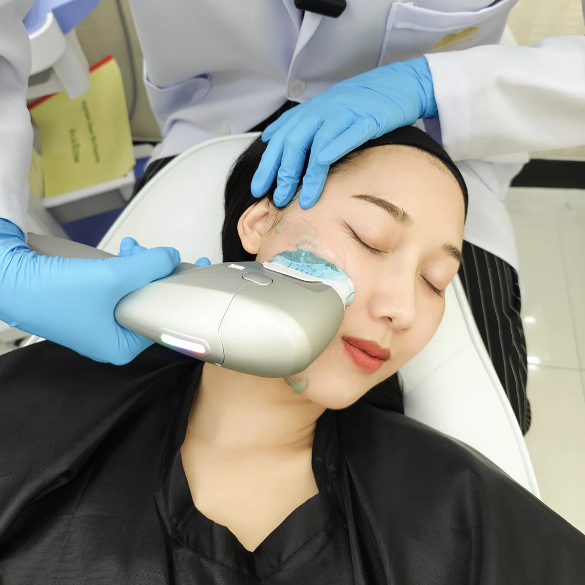 Noninvasive HIFU facial skin‑tightening treatment: clinician applies device with gel to patients cheek.