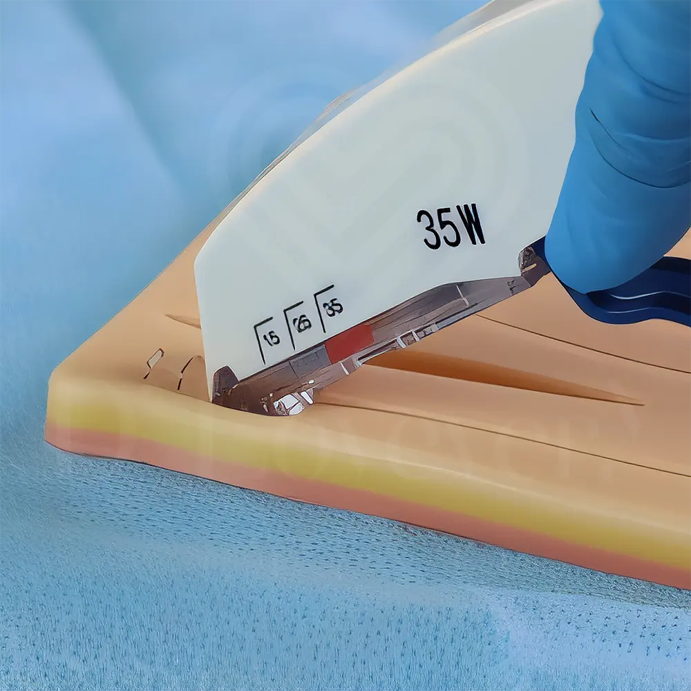 Gloved hand using surgical stapler on synthetic skin training model