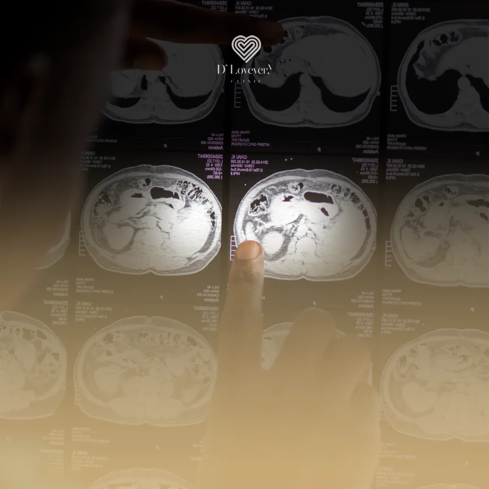 Doctor pointing at CT brain scans on illuminated radiology display