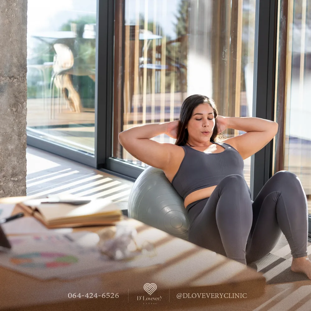 Person doing core workout on exercise ball in sunlit studio
